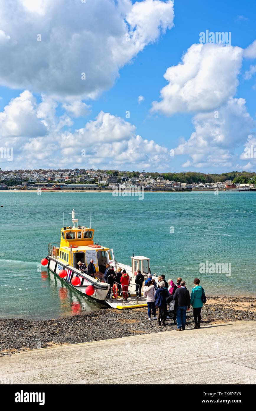 The view across the River Camel estuary from Rock with the passenger ferry arriving rom Padstow on a sunny spring day, North Cornwall England UK Stock Photo