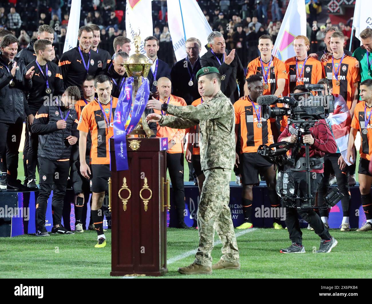 RIVNE, UKRAINE - MAY 15, 2024 - Colonel Stanislav Kerod presents the trophy to FC Shakhtar Donetsk after the team won the 2023/24 Ukrainian Cup final match against FC Vorskla Poltava at the Avanhard Stadium, Rivne, western Ukraine. The  Orange-and-Blacks claimed a 2-1 win over their rivals from Poltava and took home the Ukrainian Cup for the 14th time. On May 11, the Miners won the 2023/24 Ukrainian Premier League title early by beating FC Dynamo Kyiv 1-0 in Lviv. Thus, the Donetsk team achieved a golden double for the 2023/24 season and became the most decorated club since Ukraine’s independe Stock Photo