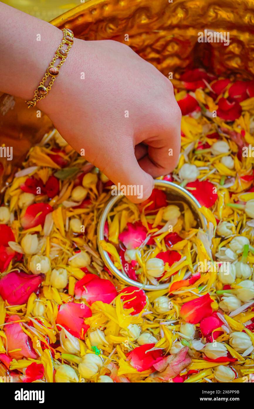 In Songkran Day, pour water on the hands of revered elders and ask for