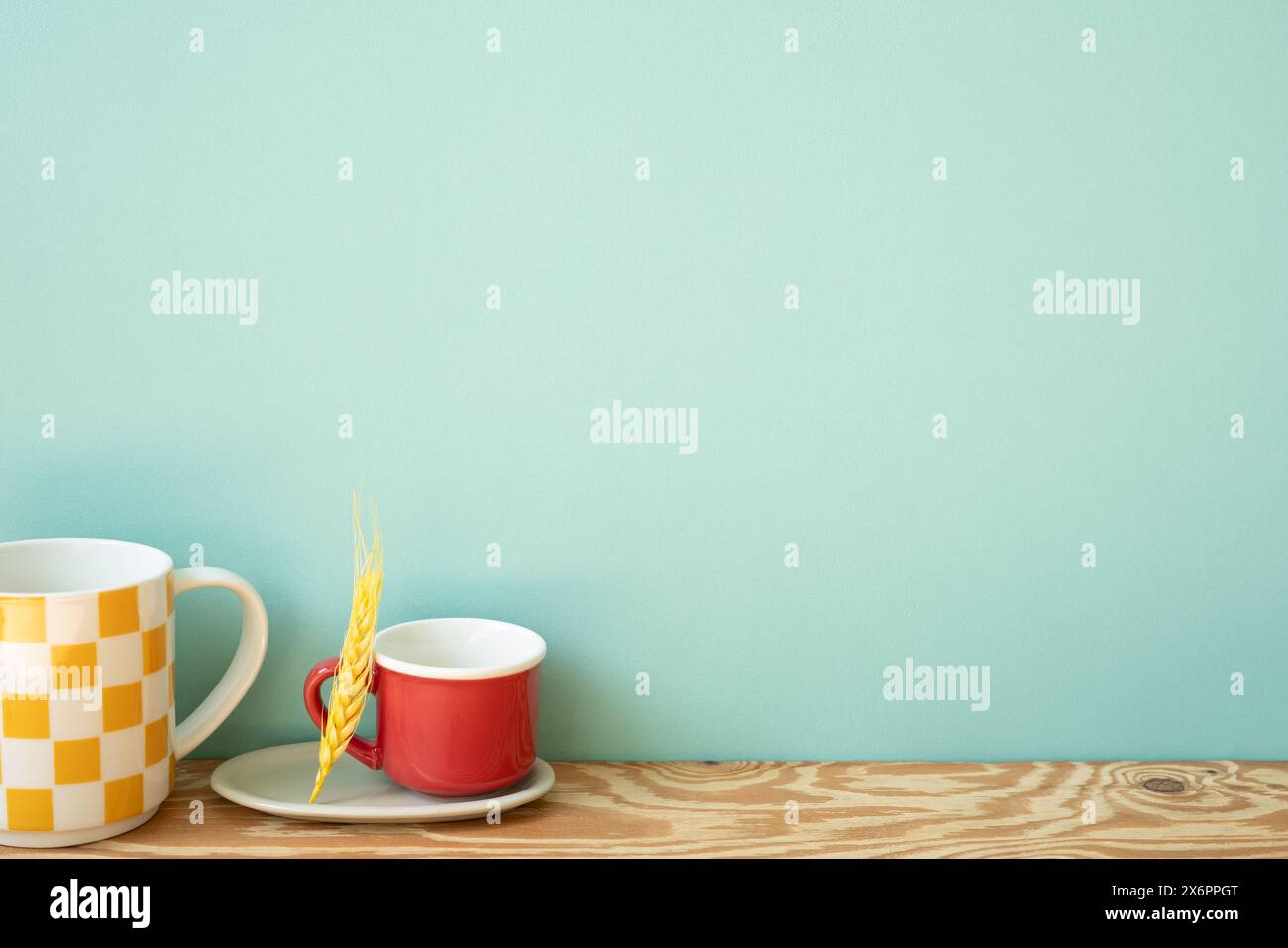 Empty mug cups on wooden shelf. mint wall background Stock Photo