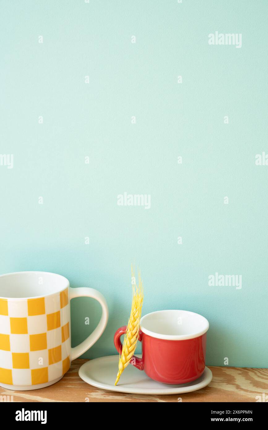 Empty mug cups on wooden shelf. mint wall background Stock Photo
