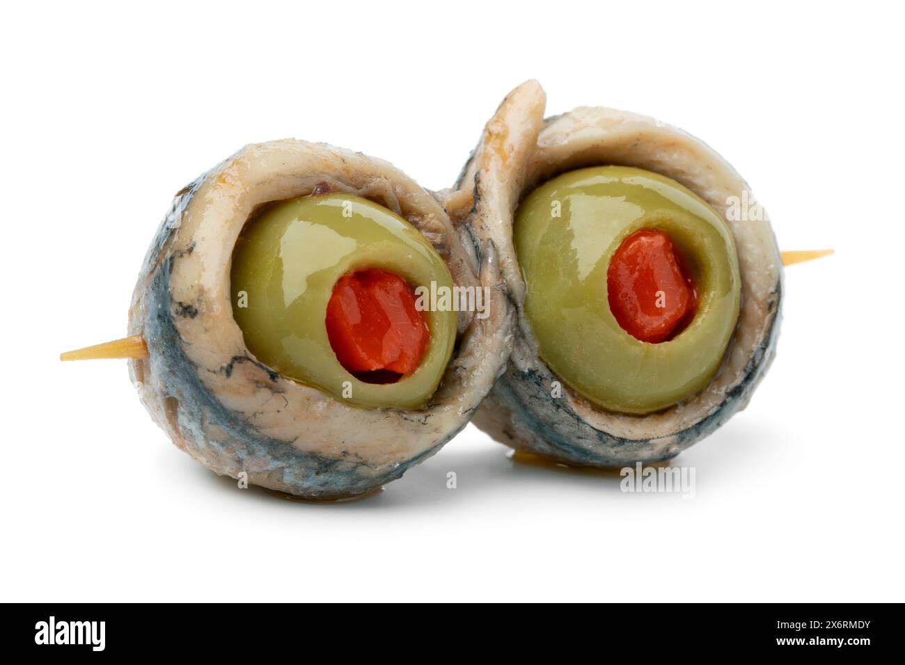 Spanish tapas, stick with a pair of green olives stuffed with red pepper and anchovy isolated on white background close up Stock Photo