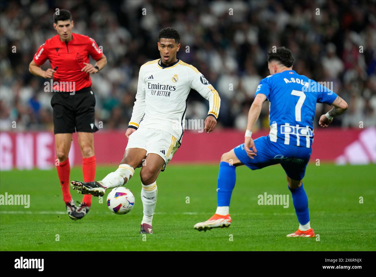 Madrid, Spain. 14th May, 2024. Jude Bellingham of Real Madrid and Alex Sola of Deportivo Alaves during the La Liga match between Real Madrid and Deportivo Alaves played at Santiago Bernabeu Stadium on May 14, 2024 in Madrid, Spain. (Photo by Cesar Cebolla/PRESSINPHOTO) Credit: PRESSINPHOTO SPORTS AGENCY/Alamy Live News Stock Photo