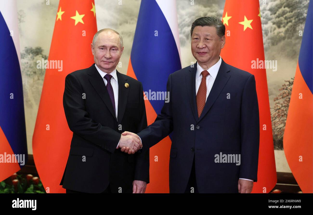 Beijing, China. 16th May, 2024. Russian President Vladimir Putin, left, shakes hands with Chinese President Xi Jinping, right, before the start of bilateral meetings at the Great Hall of the People, May 16, 2024, in Beijing, China. Credit: Kremlin Pool/Russian Presential Press Service/Alamy Live News Stock Photo