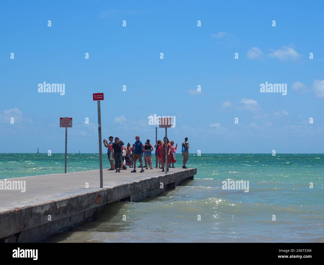 Tourists at the end of a pier overlooking the Straits of Florida, Key ...