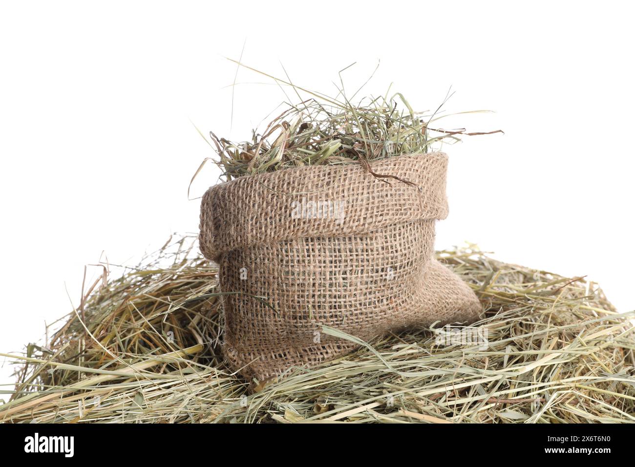 Dried hay and burlap sack isolated on white Stock Photo