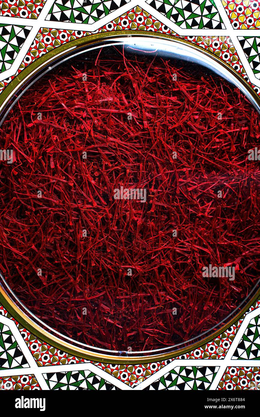 Vibrant Red Saffron Threads in Decorative Moroccan Tin Stock Photo