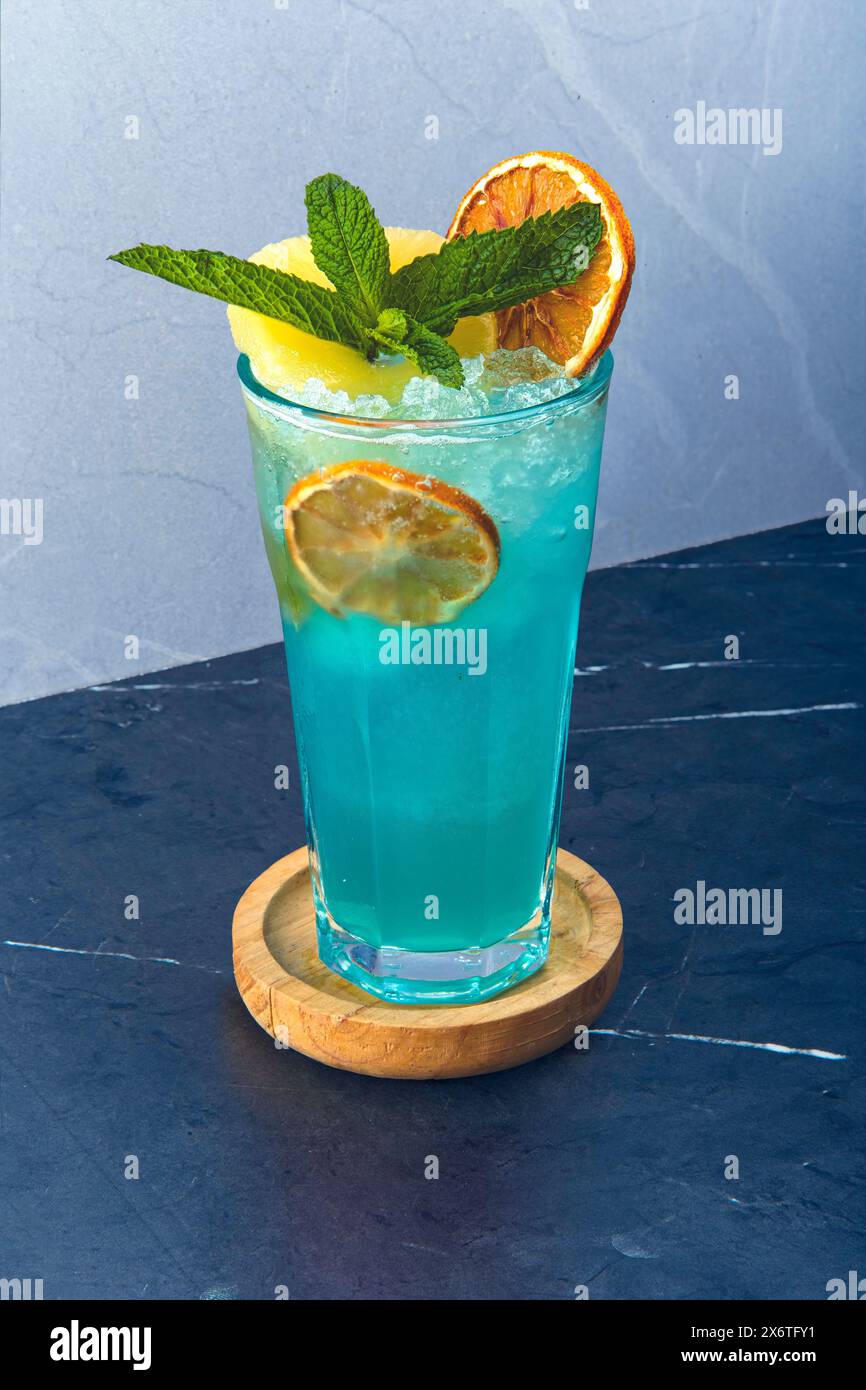 Refreshing Blue Cocktail With Mint And Citrus Garnish Stock Photo - Alamy