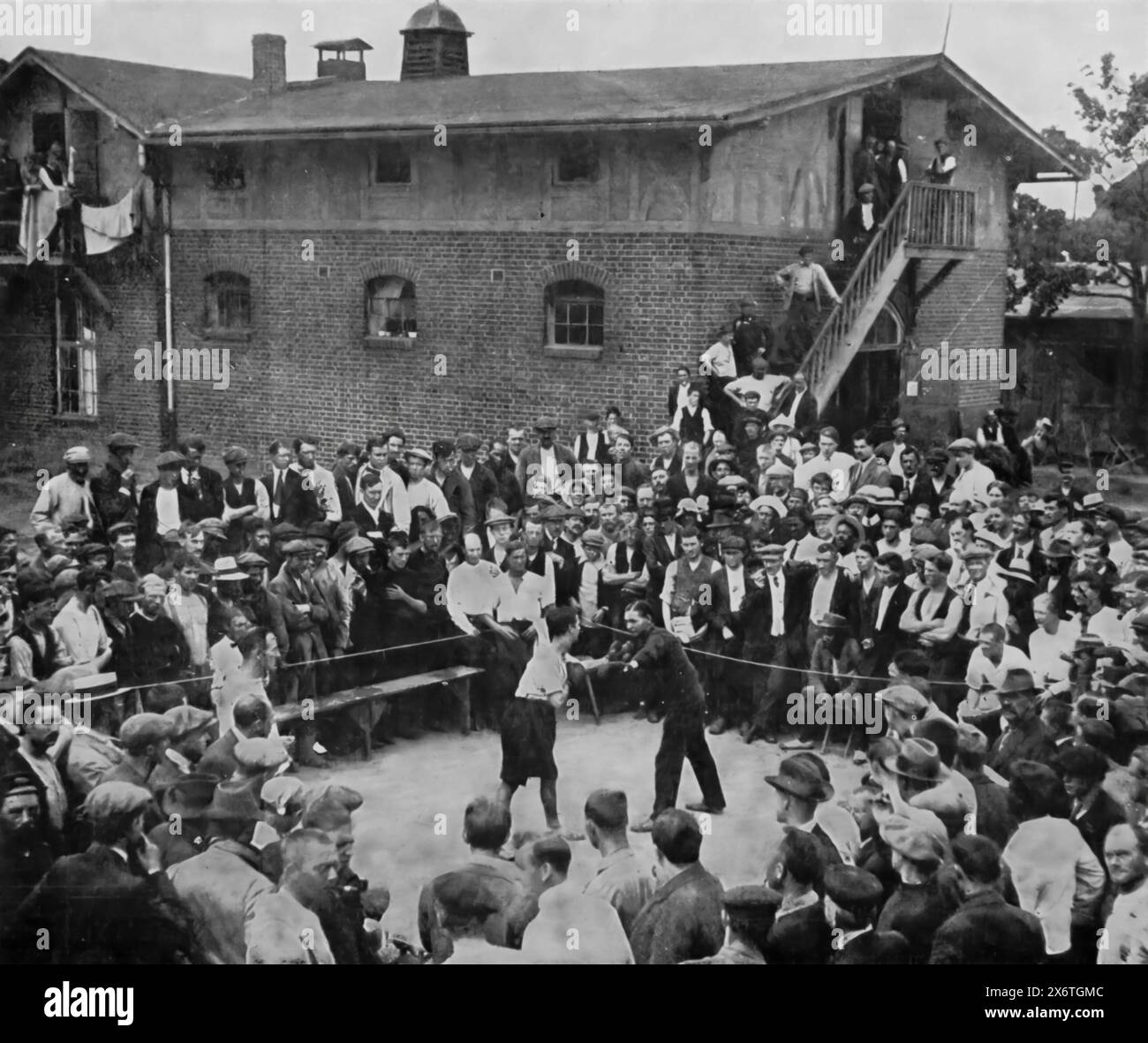 A photograph of a boxing match in the civilian internment camp at Ruhleben, Berlin, during the First World War, circa 1916. The camp housed mainly British civilians who were in Germany at the outbreak of the war. Facing tough conditions and harsh winters, the captives sought every available means of mental and physical recreation to endure their captivity. This scene highlights the resilience and determination to maintain their morale and well-being despite the challenges they faced. Stock Photo