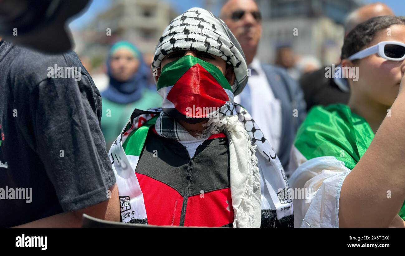 People putting up Palestinian flags march in Ramallah, West Bank on May 15, 2024. A large-scale demonstration is held in the Palestinian autonomous re Stock Photo