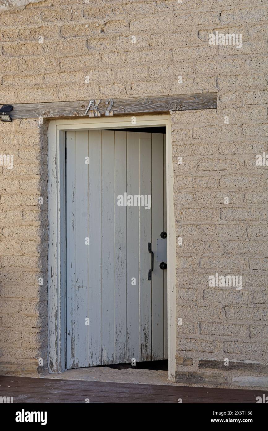 Wooden lintel over rustic doorway in reconstructed adobe style barracks ...