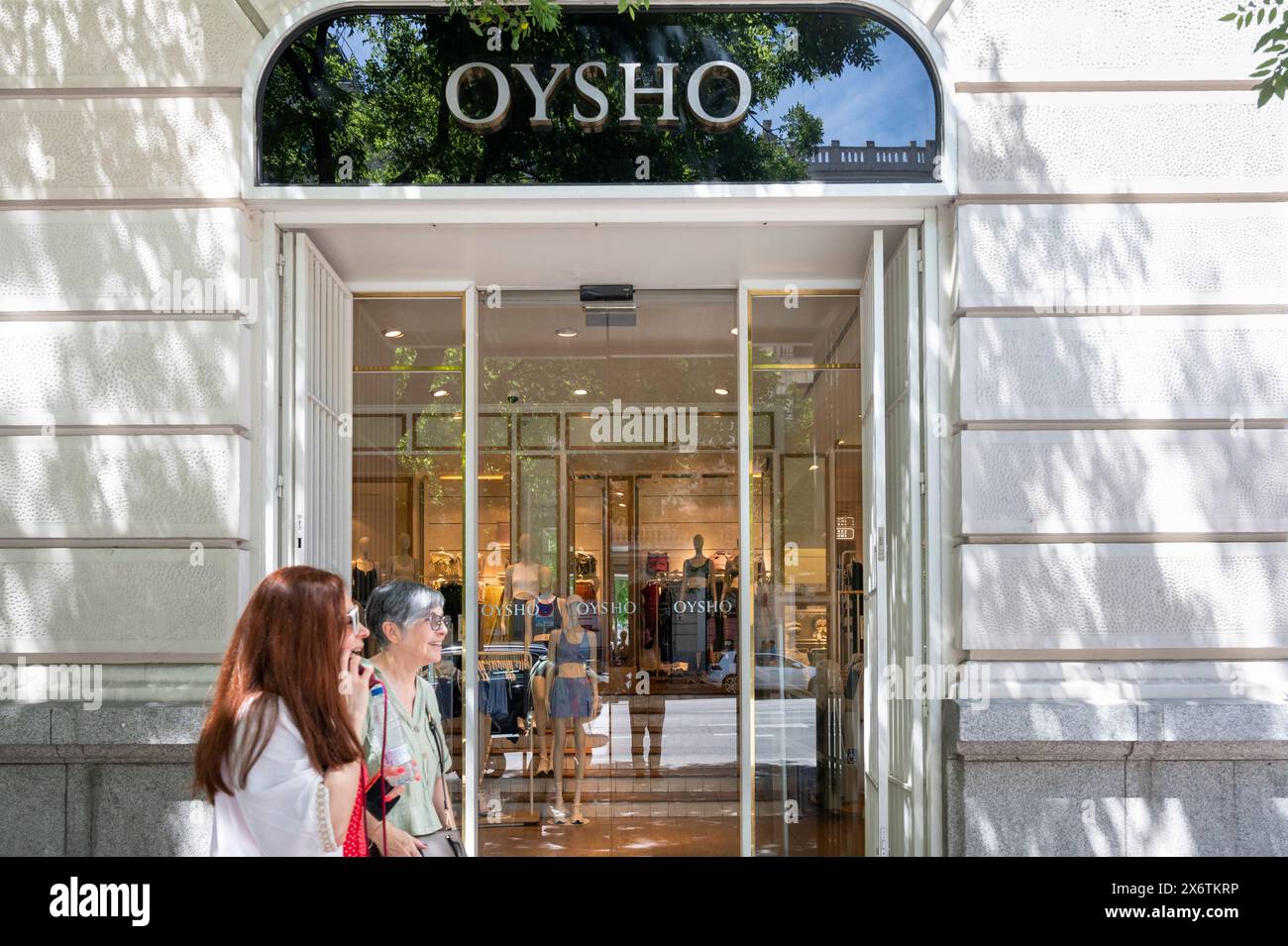 Pedestrians walk past the Spanish clothing retailer specializing in women's homeware and undergarments owned by Inditex group, Oysho, store in Spain. Stock Photo