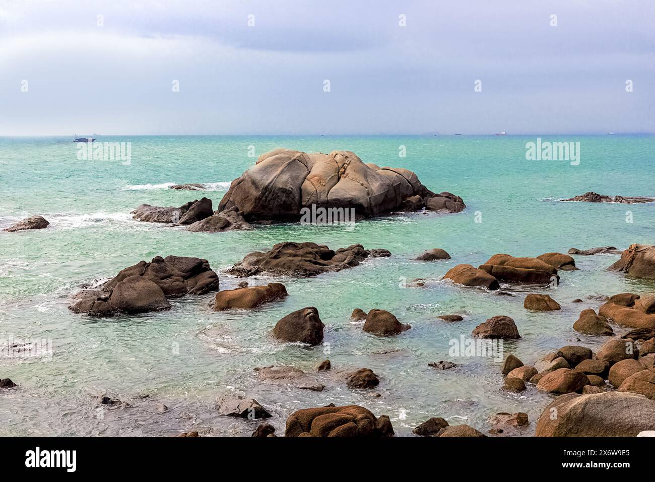 Seascape. View of large rocks along the shore of the South China Sea. Rocky shore at Sky Grottoes Park, Sanya, China Stock Photo