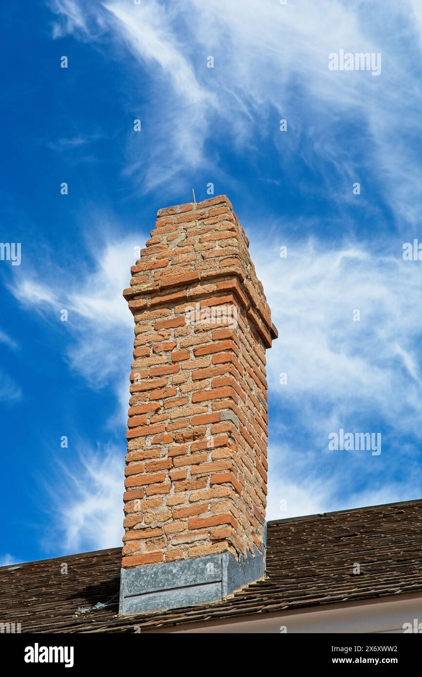 19th century red brick chimney against blue sky Stock Photo - Alamy