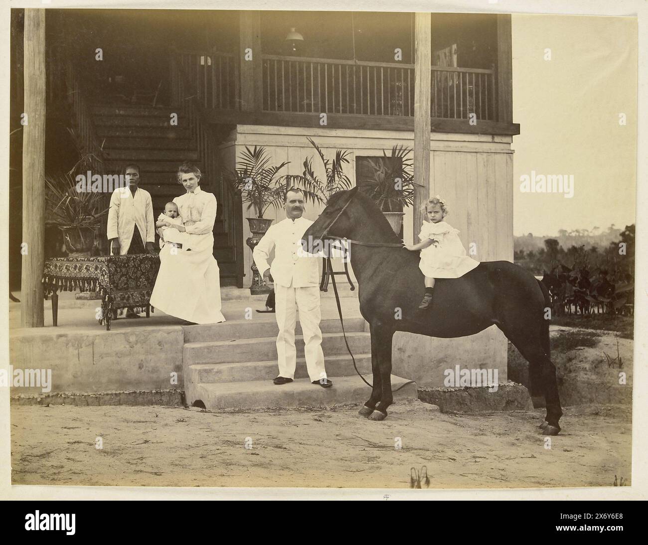 Portrait of DE. Bremer with wife, children, servant and horse in front of his house, Langkat Sumatra, photograph, Heinrich Ernst & Co, (attributed to), Bindjai Langkat, c. 1890 - c. 1900, photographic support, albumen print, height, 224 mm × width, 305 mm Stock Photo