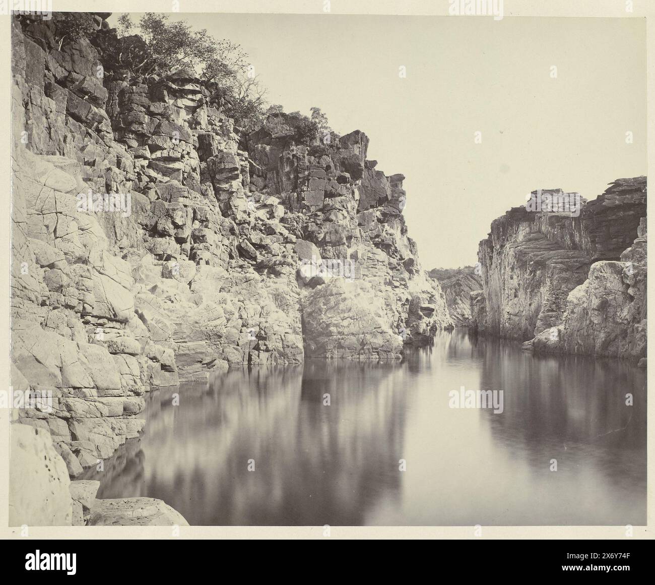 View of the Marble Rocks along the Narmada river near Jabalpur, Madhya Pradesh, India, Nowadays the Marble Rocks are a famous tourist destination. According to ancient legends, the Narmade River contains a Shavist power. If a believer would bathe in the river during the full moon, he or she could receive healing powers., photograph, Samuel Bourne, (attributed to), Marble Rocks, 1863 - 1870, paper, albumen print, height, 370 mm × width, 415 mm Stock Photo