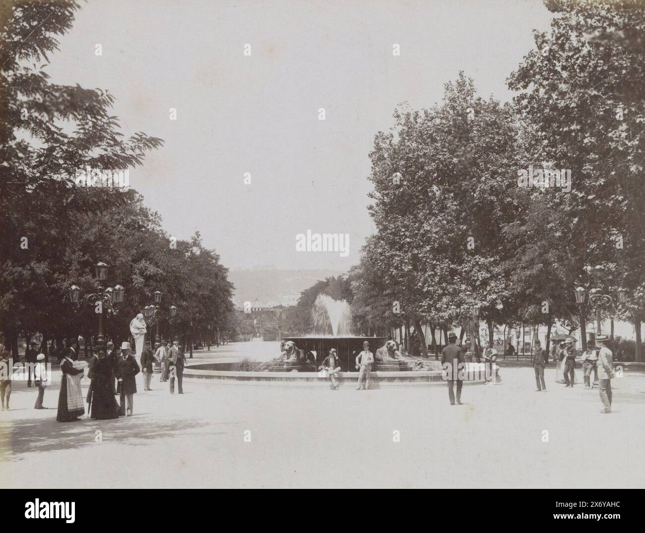 Square with a fountain and strolling people in Naples, NAPOLI Villa (title on object), Part of Travel album with photos of sights in Italy and France., photograph, Giorgio Sommer, Naples, c. 1880 - c. 1900, paper, albumen print, height, 200 mm × width, 256 mm Stock Photo