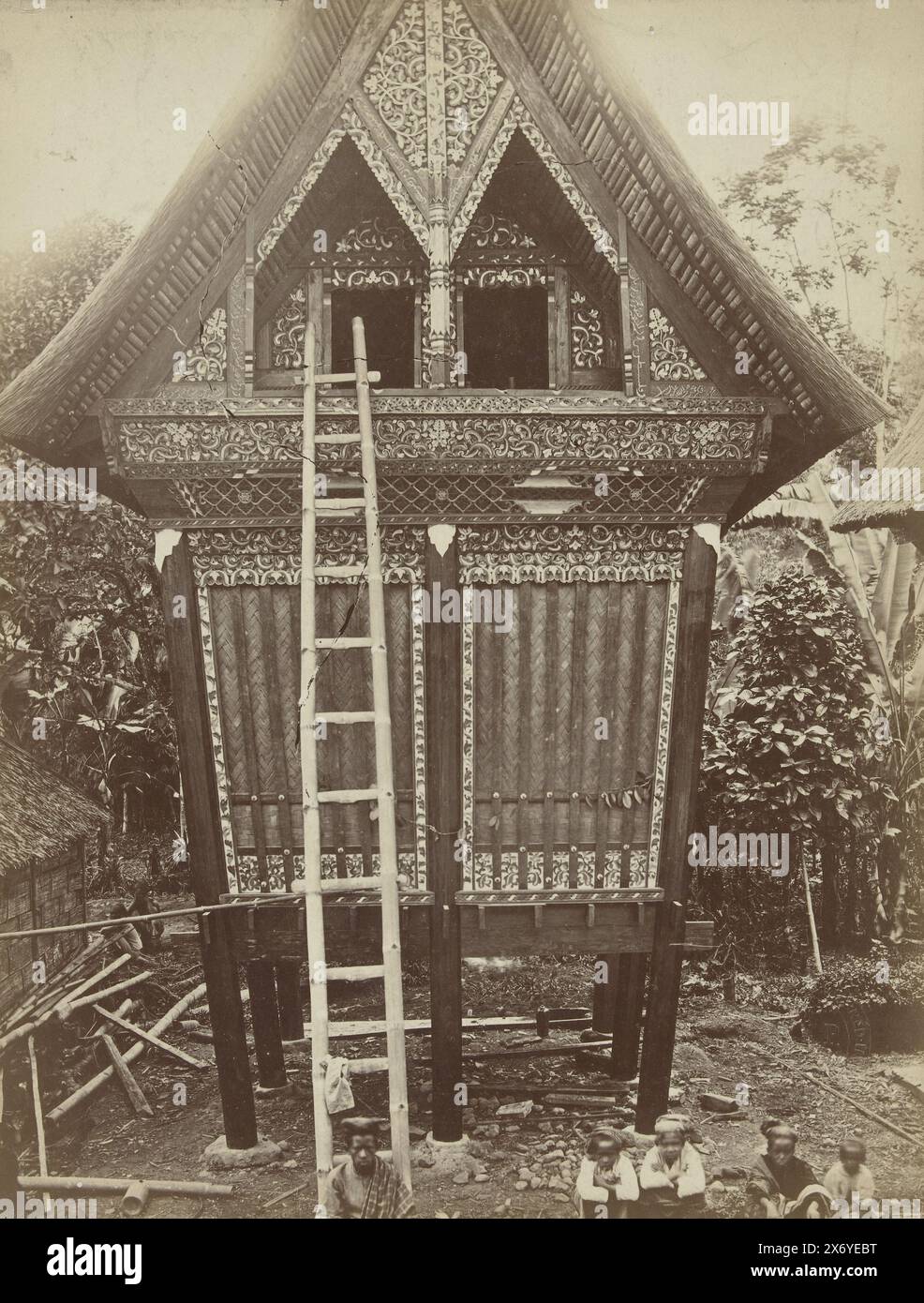 Rice barn with wood carvings in West Sumatra, Sumatra. Fort de Kock - Lombang (Rice Barn) (title on object), photograph, Woodbury & Page, (mentioned on object), Sumatra, 1860 - 1890, paper, albumen print, height, 240 mm × width, 183 mm, height, 265 mm × width, 204 mm Stock Photo