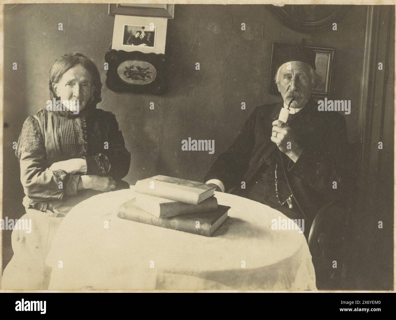 Portrait of L.H.F. Rontgen and his wife Christine van Wijngaard at the table, L.H.F. Rontgen and wife Christine van Wijngaard (title on object), photograph, anonymous, unknown, 1910 - 1930, photographic support, gelatin silver print, height, 110 mm × width, 152 mm, height, 236 mm × width, 297 mm Stock Photo