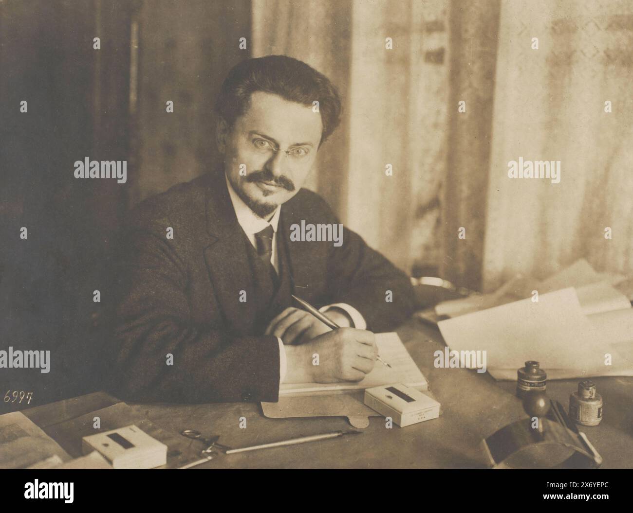 Portrait of Leon Trotsky at a desk, photograph, anonymous, Brest, 1918, baryta paper, gelatin silver print, height, 299 mm × width, 397 mm Stock Photo