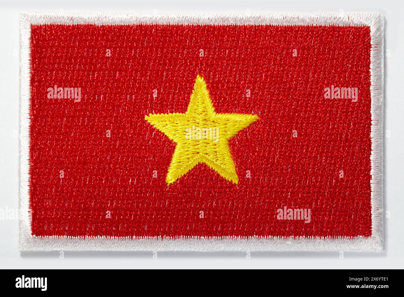 Embroidered emblem of the Vietnamese national flag with one yellow star in the middle of red Stock Photo