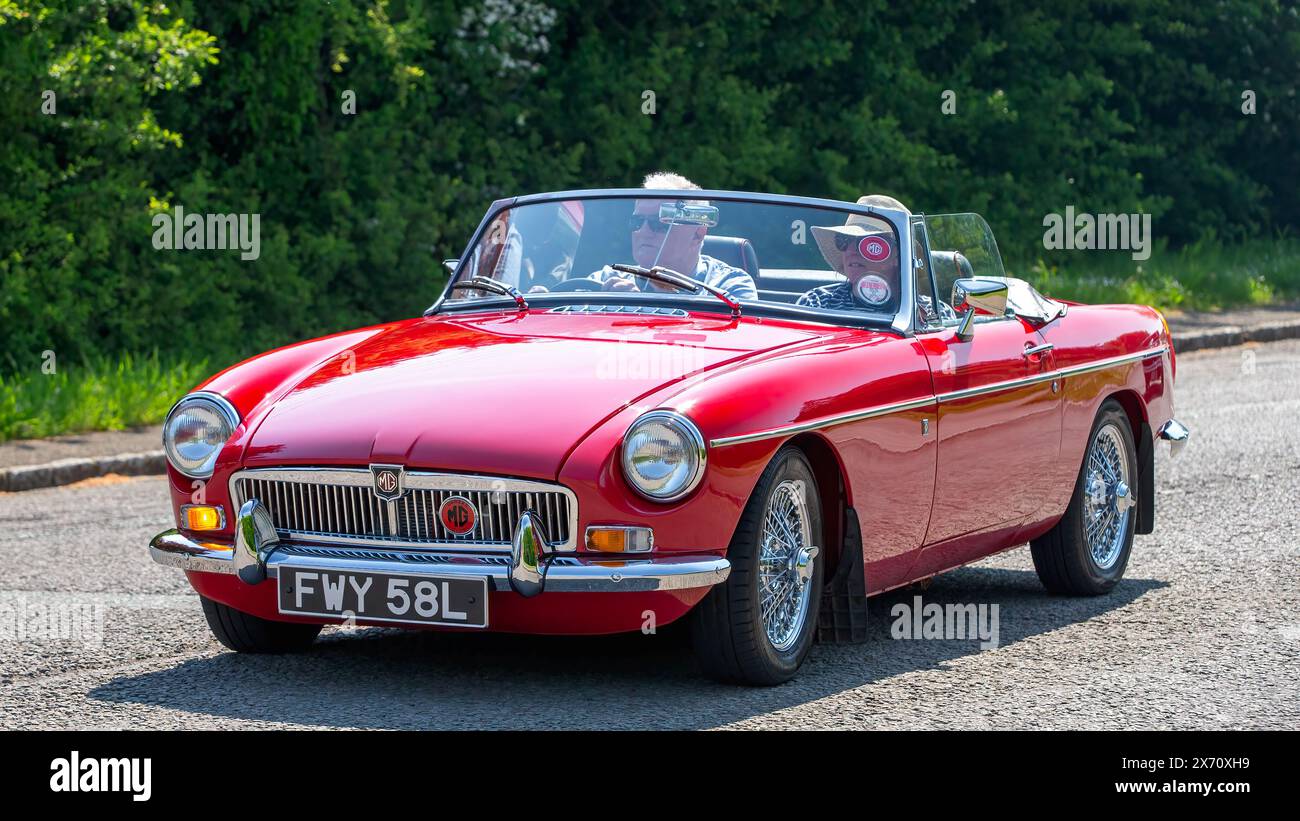 Stoke Goldington,UK - May 11th 2024: 1972 red MG B classic car driving on a British road Stock Photo