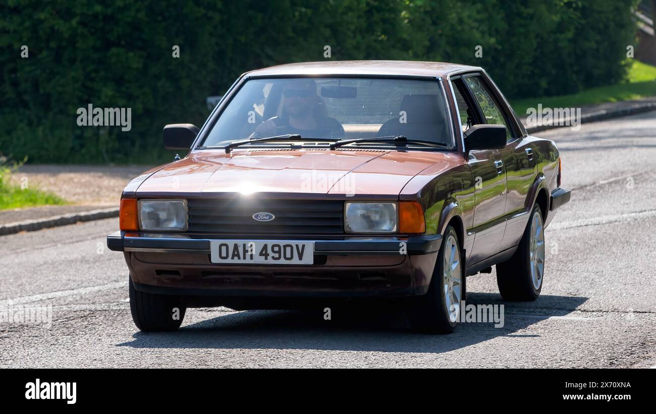 Stoke Goldington,UK - May 11th 2024: 1980 brown Ford Cortina classic car driving on a British road Stock Photo