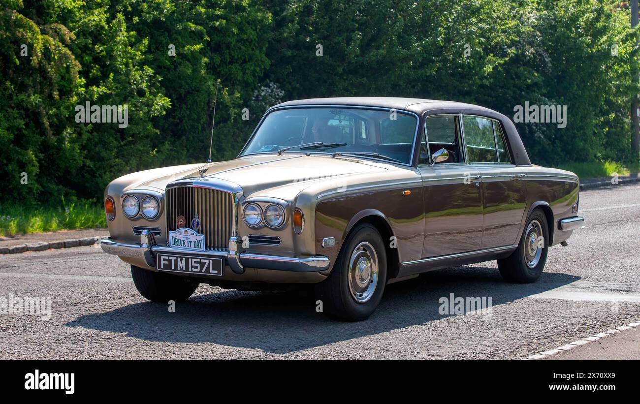 Stoke Goldington,UK - May 11th 2024: 1972 gold Bentley  classic car driving on a British road Stock Photo
