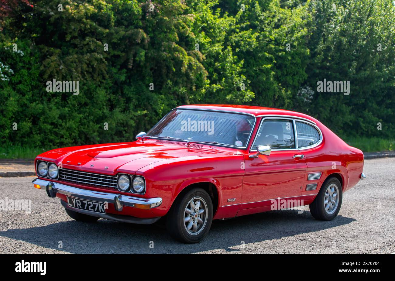 Stoke Goldington,UK - May 11th 2024:1972 red Ford Capri classic car driving on a British road Stock Photo
