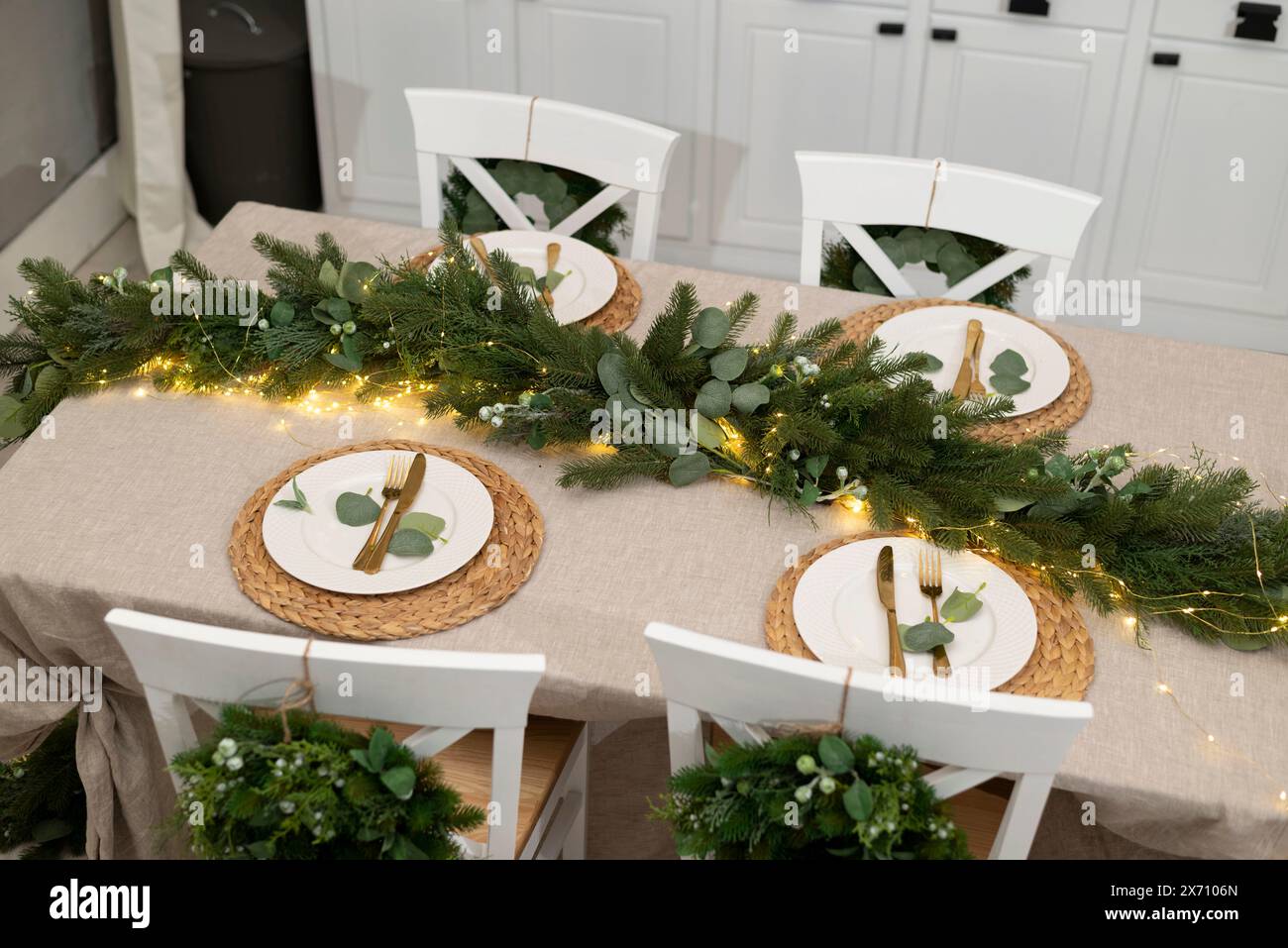 Christmas kitchen decor and table settings. Rustic cuisine at Christmas. Details of scandinavian cuisine in gold color. Kitchen island festive. Stock Photo