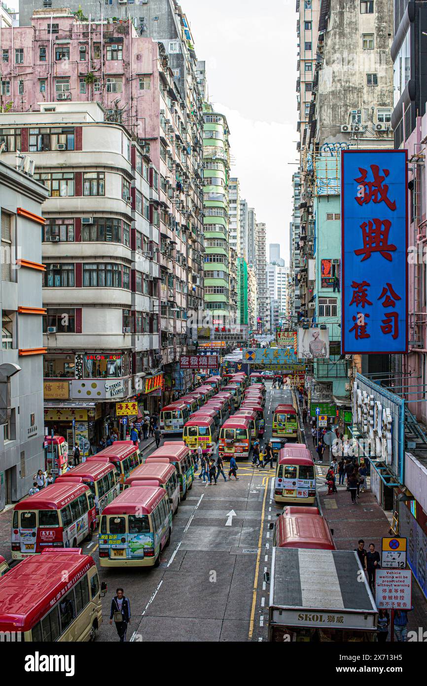 Rows of Red Mini Bus in Crowded Hong Kong street in Hong Kong . Stock Photo