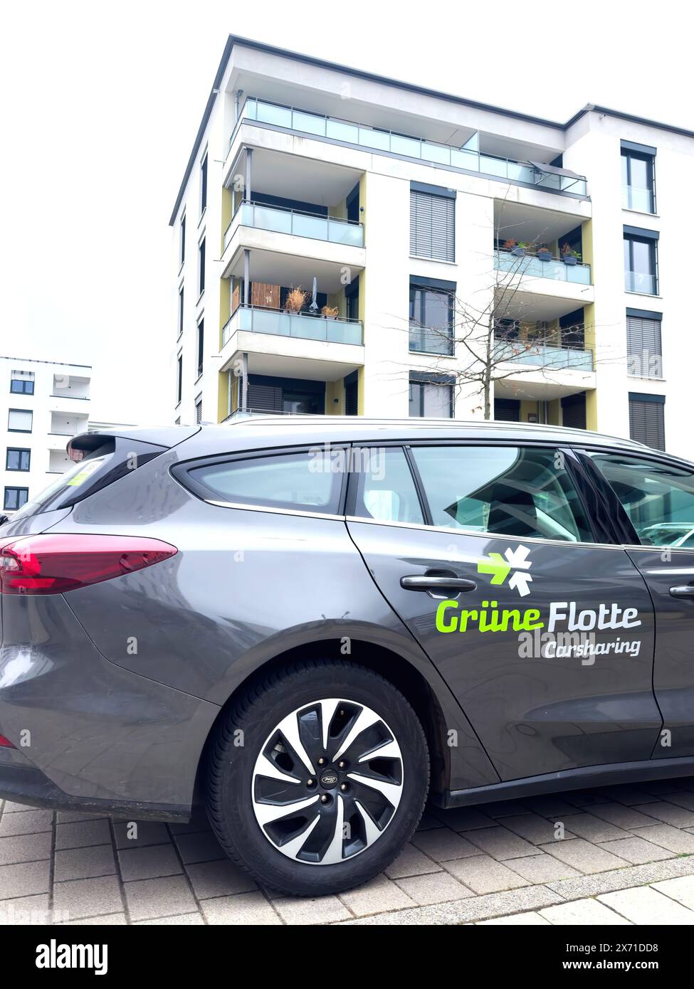 Image showcasing Freiburg, Germany - Mar 4, 2024: A Grune Flotte carsharing vehicle is ...