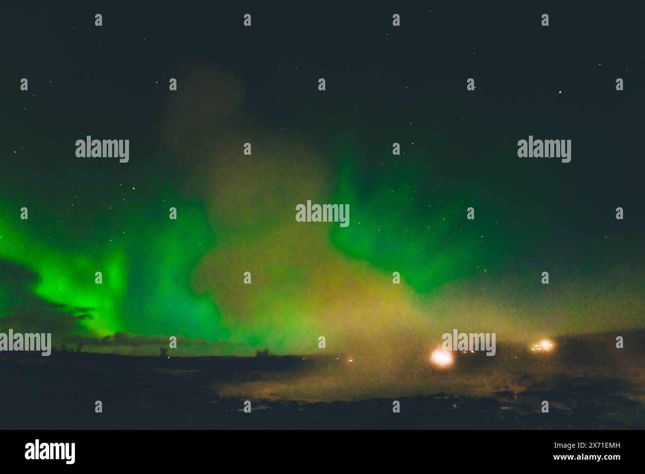 Beautiful aurora borealis over Geysir hot springs landmark in Iceland