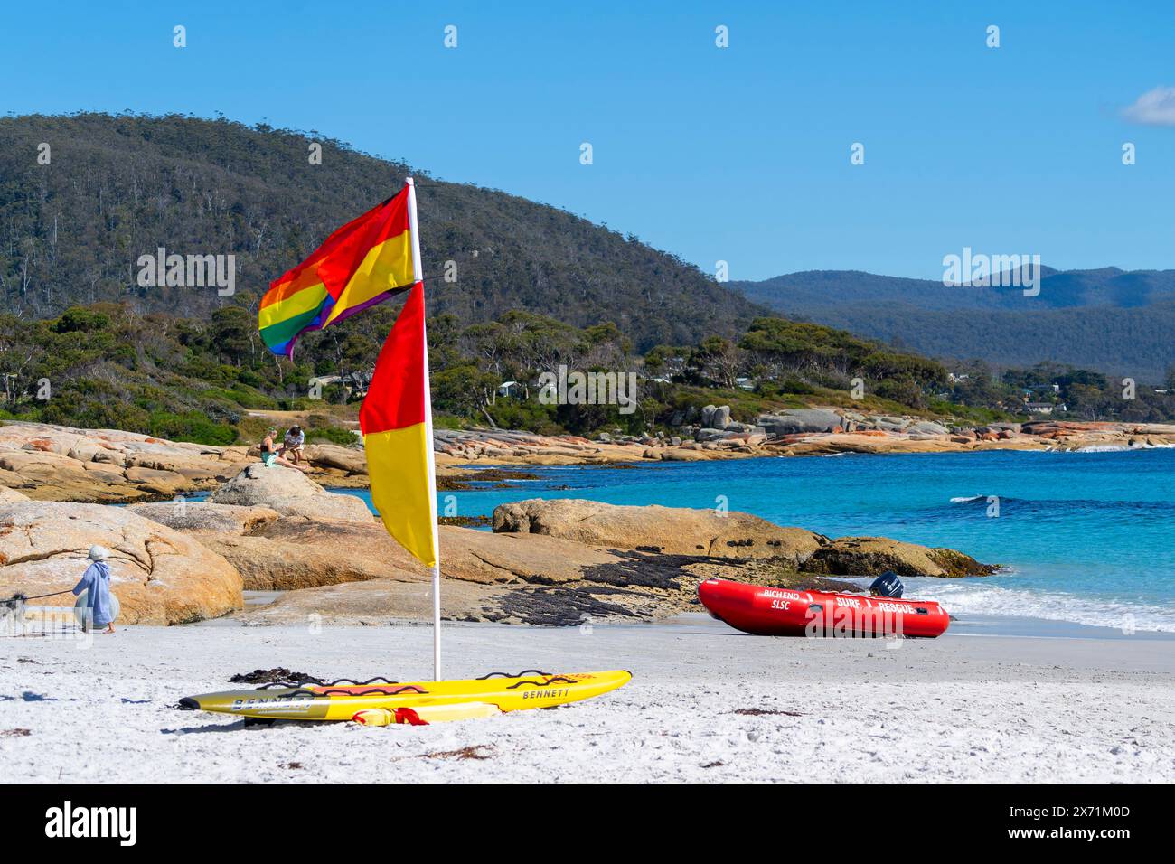 Surf Life Saving flag on white sand at Waubs Bay, Bicheno Beach East Coast Tasmania Stock Photo