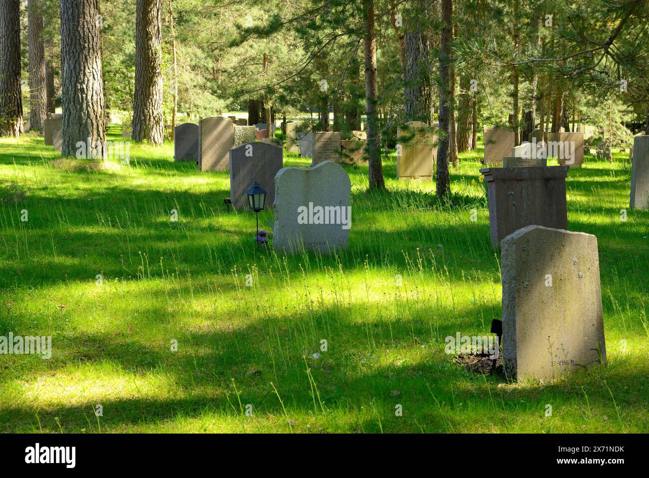 Beautiful summer view of a row of gravestones at Unesco heritage Woodland cemerery in Stockholm - Sweden Stock Photo