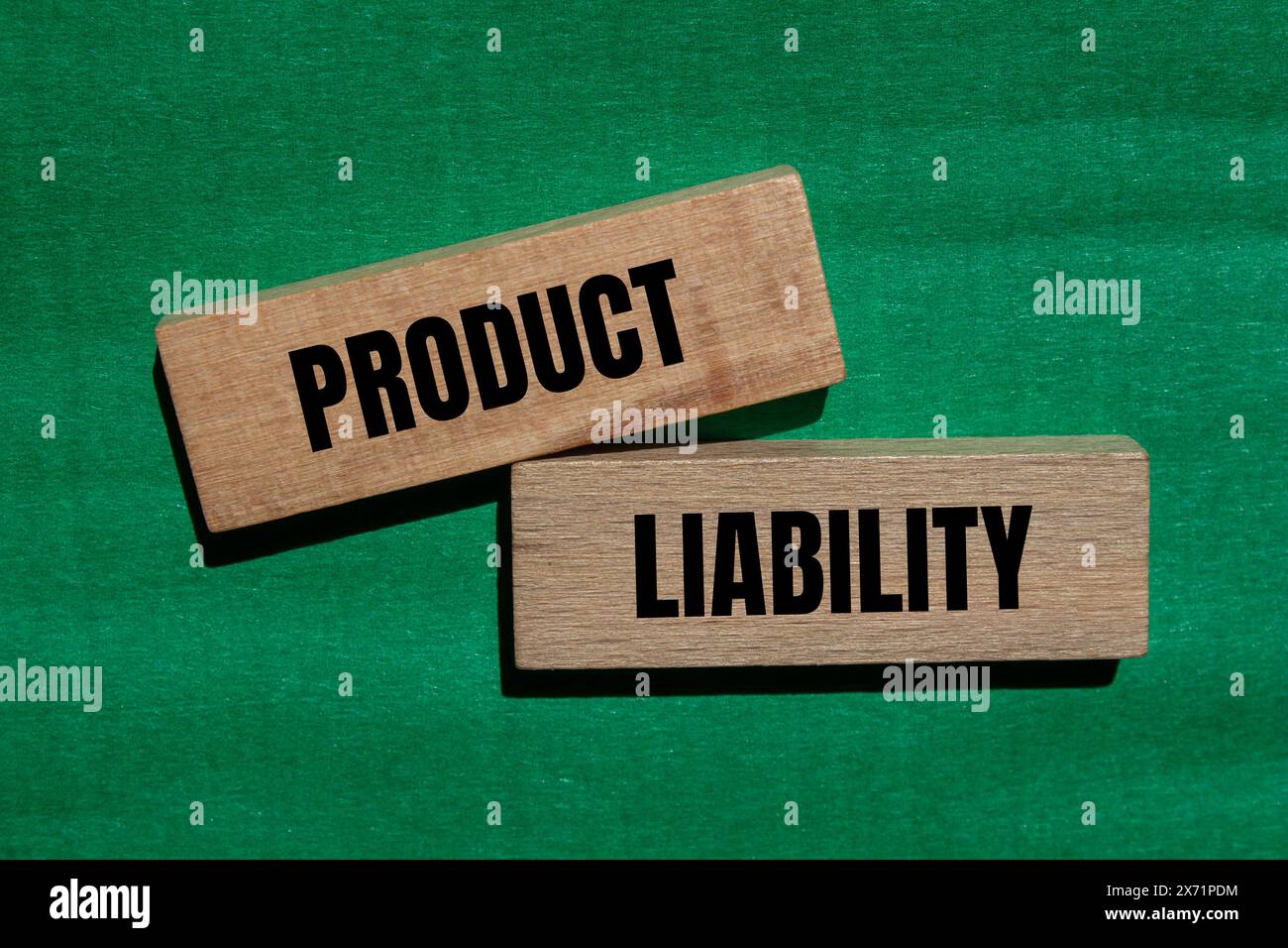 Product liability words written on wooden blocks with green background. Conceptual product liability symbol. Copy space. Stock Photo