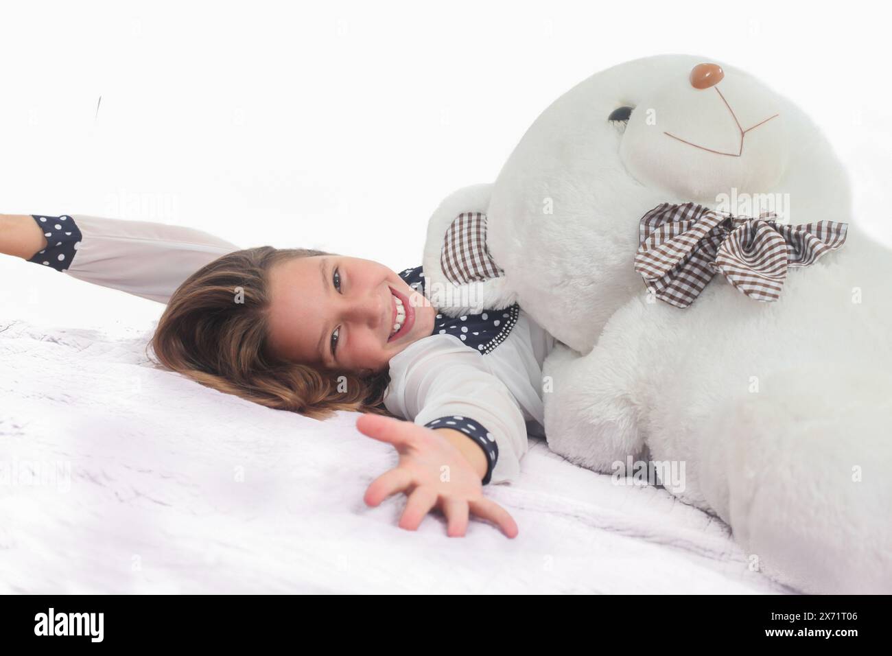 cute cheerful preteen girl with big teddy bear on white background ...