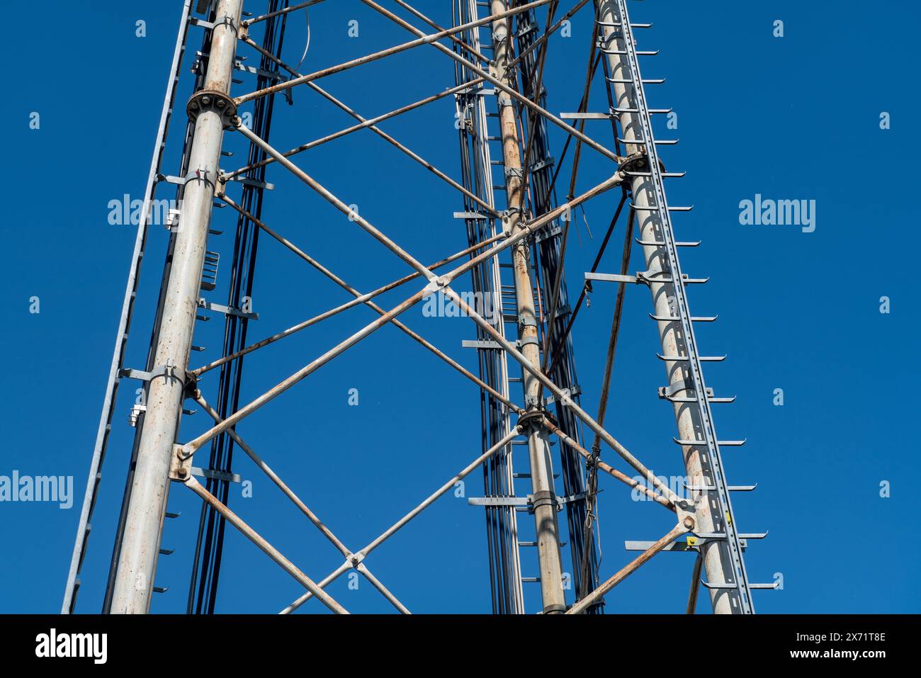 Steel pylon details, reticular structure of a repeater antenna for radio, telephone and communications bands. Stainless steel tie rods and nuts. Stock Photo