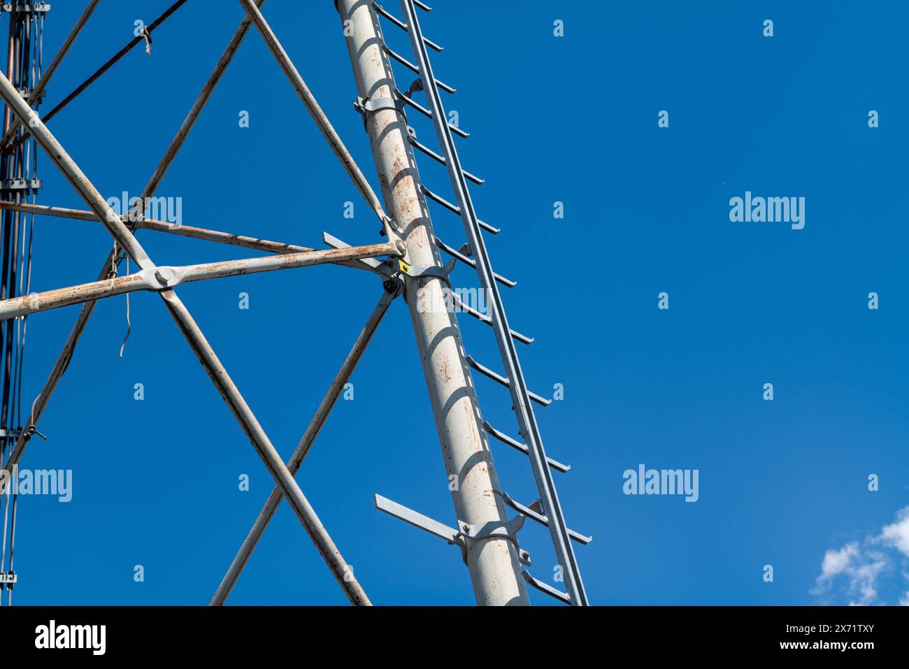 technical ladder for galvanized steel truss anchored to the reticular structure of a repeater antenna for radio, telephone and communications bands. S Stock Photo