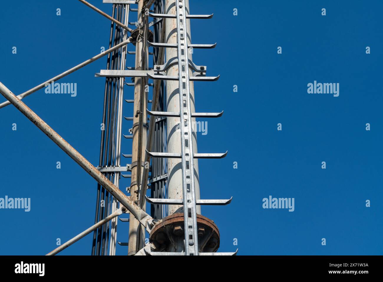 technical ladder for galvanized steel truss anchored to the reticular structure of a repeater antenna for radio, telephone and communications bands. S Stock Photo