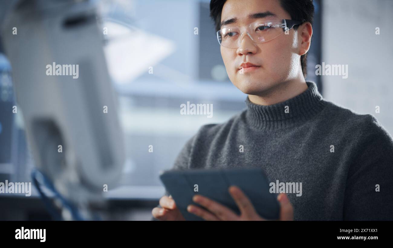 Student Using Tablet to Controll Robotic Hand. Bionic Arm Moving in ...