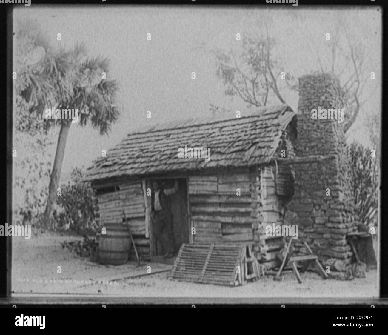 Old cabin at Turkey Creek, Attribution to Jackson based on Catalogue of the W.H. Jackson Views (1898)., Corresponding glass transparency (same series code) available on videodisc frame 1A-28783., Listed in Detroit, Catalogue F (1899)., Detroit Publishing Co. no. 03638., Gift; State Historical Society of Colorado; 1949,  Log cabins. , African Americans. , Rivers. , United States, Florida, Indian River. , United States, Florida, Turkey Creek. Stock Photo