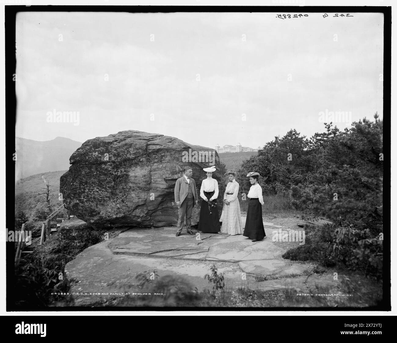 Mr. H.E. Eder and family at Bowlder i.e. Boulder Rock, Hotel Kaaterskill in background., '342 G' on negative., Detroit Publishing Co. no. 042885., Gift; State Historical Society of Colorado; 1949,  Families. , Resorts. , Rock formations. , United States, New York (State), Catskill Mountains. Stock Photo