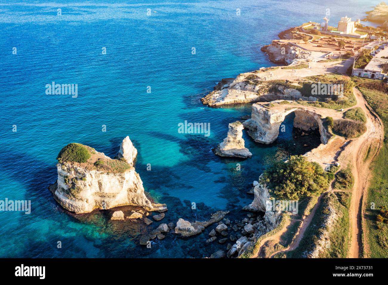 Stunning seascape with cliffs rocky arch and stacks (Faraglioni) at Torre Sant Andrea, Salento coast, Puglia region, Italy. Beautiful cliffs and sea s Stock Photo