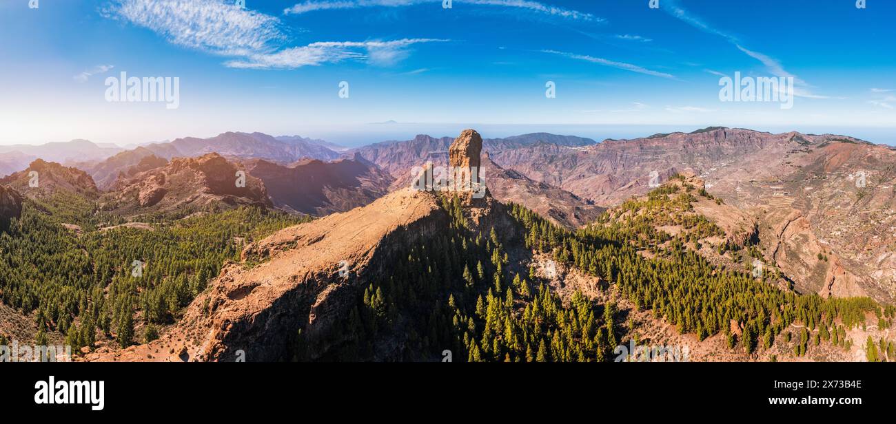 Roque Nublo and Pico de Teide in the background on Gran Canaria Island, Spain. Panoramic view of Roque Nublo sacred mountain, Roque Nublo Rural Park, Stock Photo