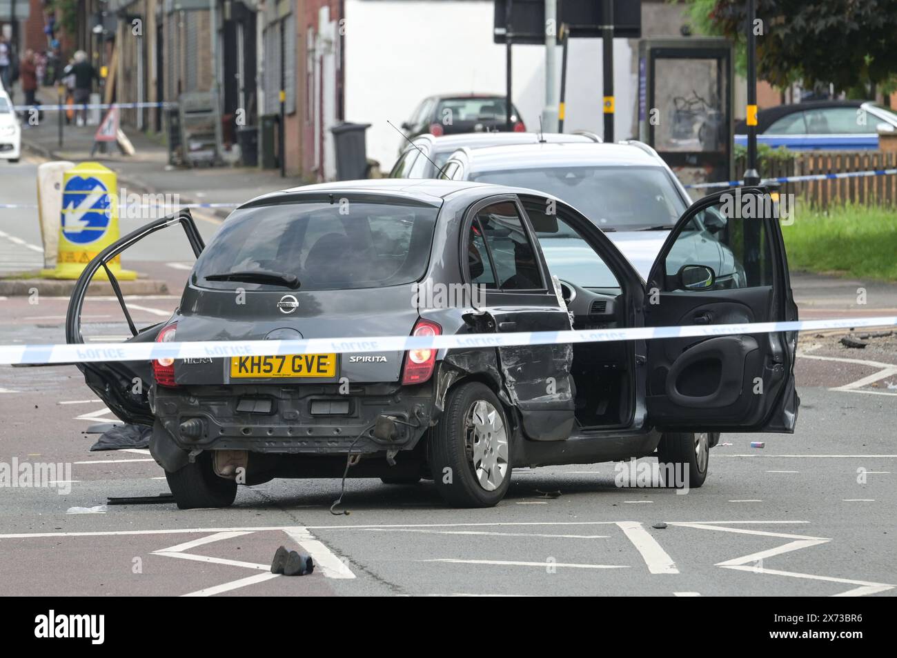 Clevedon Road, Birmingham, May 17th 2024 - West Midlands Police have closed several roads in the Balsall Heath area of Birmingham after a police chase led to the fleeing driver of a Nissan Micra to crash into another vehicle. One male occupant of the Micra was seriously injured and taken to hospital under arrest. Two other men fled the scene, one was arrested a short time later and the other is outstanding. Officers flooded the area of Clevedon Road and Lincoln Street setting up a large cordon. A mens trainer and black jacket along with first aid could be seen on the road at a pedestrian cross Stock Photo