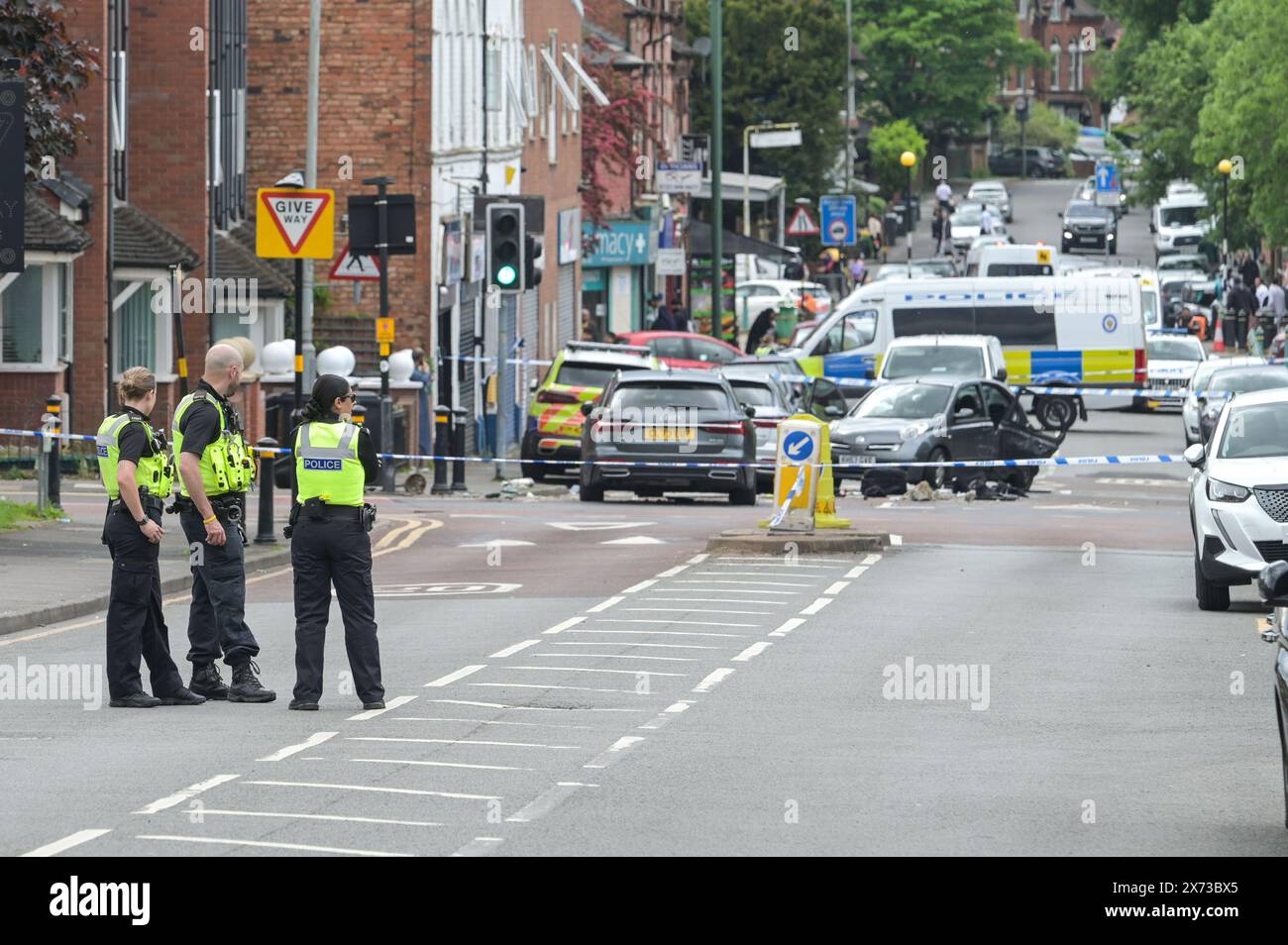 Clevedon Road, Birmingham, May 17th 2024 - West Midlands Police have closed several roads in the Balsall Heath area of Birmingham after a police chase led to the fleeing driver of a Nissan Micra to crash into another vehicle. One male occupant of the Micra was seriously injured and taken to hospital under arrest. Two other men fled the scene, one was arrested a short time later and the other is outstanding. Officers flooded the area of Clevedon Road and Lincoln Street setting up a large cordon. A mens trainer and black jacket along with first aid could be seen on the road at a pedestrian cross Stock Photo