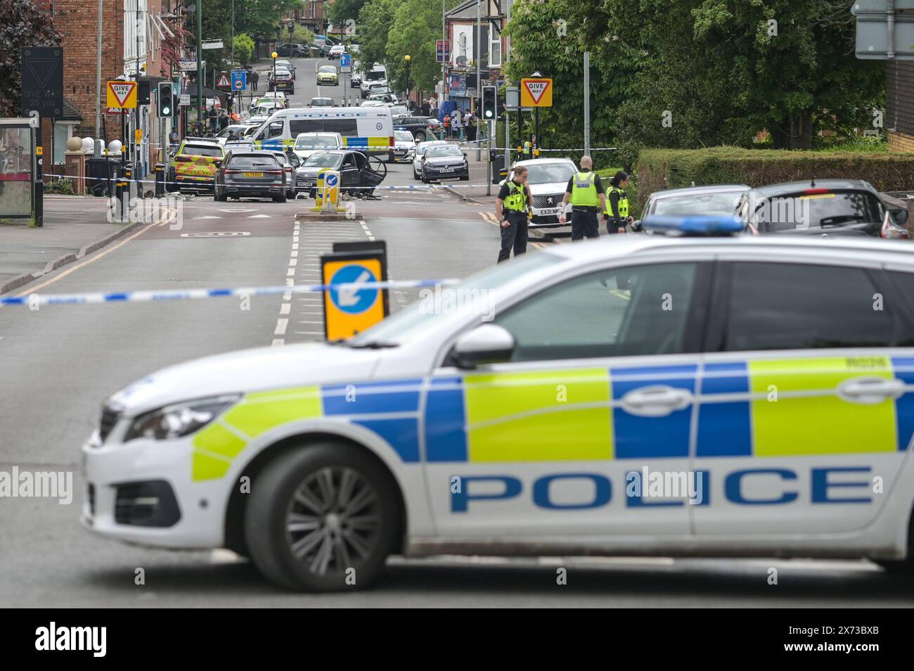 Clevedon Road, Birmingham, May 17th 2024 - West Midlands Police have closed several roads in the Balsall Heath area of Birmingham after a police chase led to the fleeing driver of a Nissan Micra to crash into another vehicle. One male occupant of the Micra was seriously injured and taken to hospital under arrest. Two other men fled the scene, one was arrested a short time later and the other is outstanding. Officers flooded the area of Clevedon Road and Lincoln Street setting up a large cordon. A mens trainer and black jacket along with first aid could be seen on the road at a pedestrian cross Stock Photo