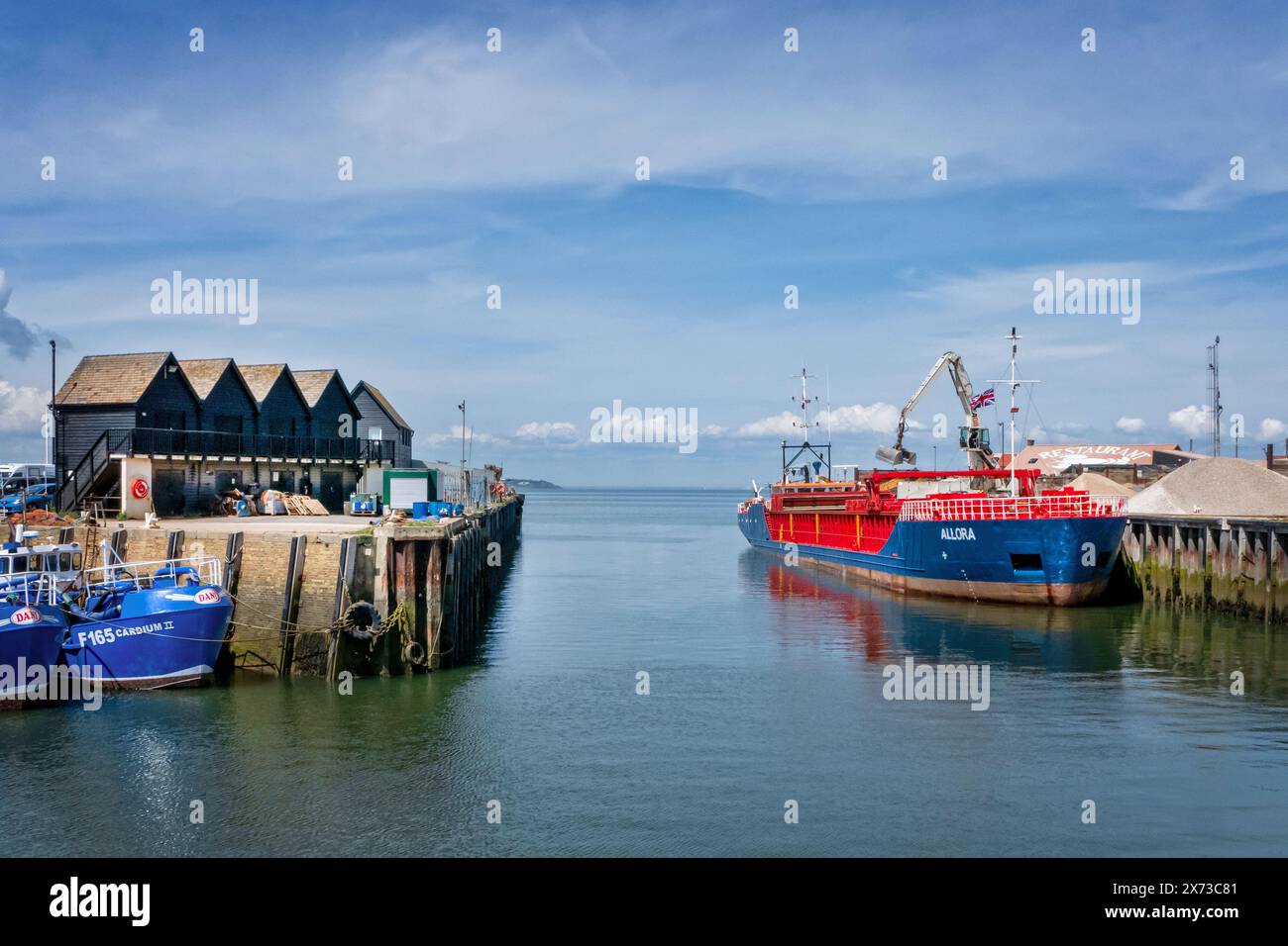 Bulk carrier Coaster with aggregates being unloaded at Whitstable harbour Kent UK Stock Photo