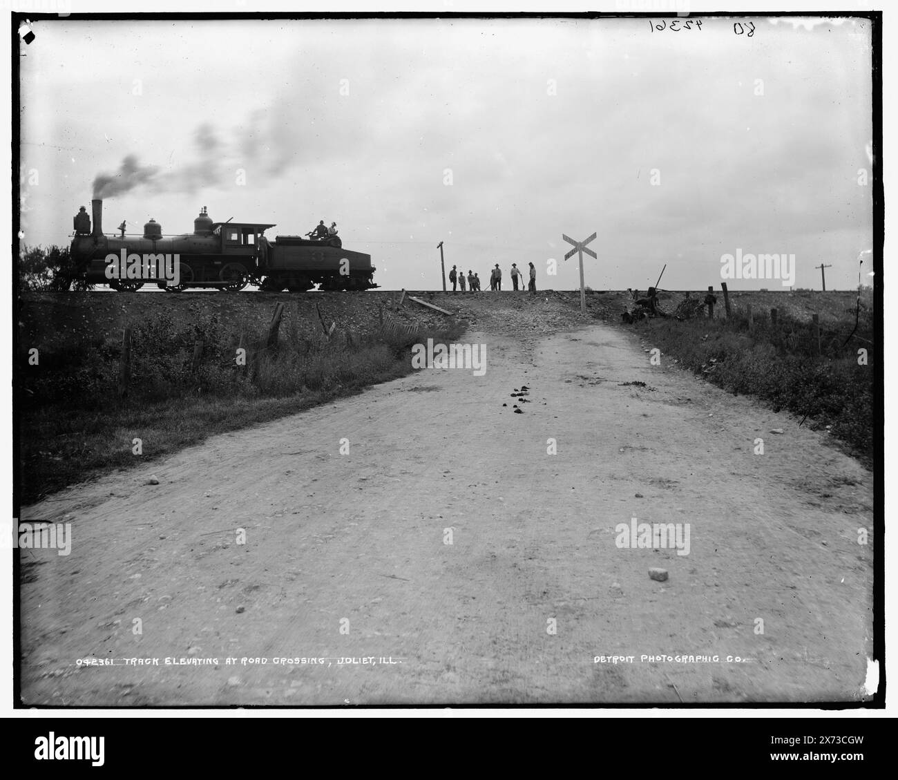 Track elevating at road crossing, Joliet, Ill., Jacket title: Chicago and Alton Railroad, track elevation at road crossing., '80' on negative., Detroit Publishing Co. no. 042361., Gift; State Historical Society of Colorado; 1949,  Railroad crossings. , Railroad locomotives. , Construction industry. , United States, Illinois, Joliet. Stock Photo